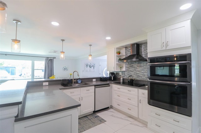 kitchen featuring tasteful backsplash, double oven, dishwashing machine, wall chimney exhaust hood, and a sink