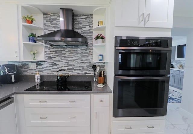 kitchen featuring double oven, open shelves, wall chimney range hood, and white cabinets