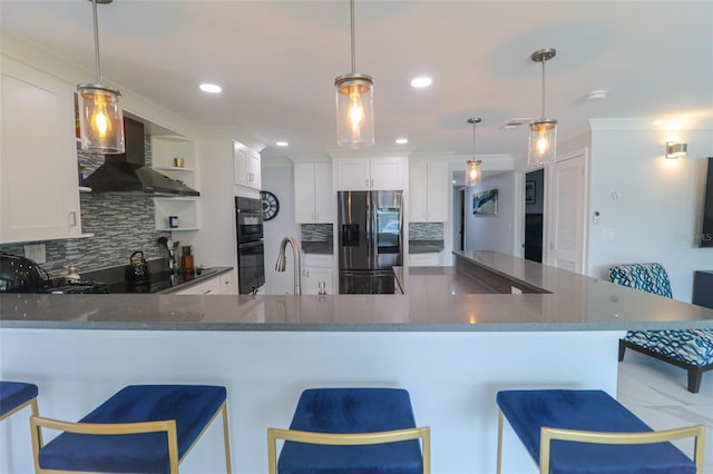 kitchen featuring black appliances, a sink, backsplash, white cabinetry, and wall chimney exhaust hood