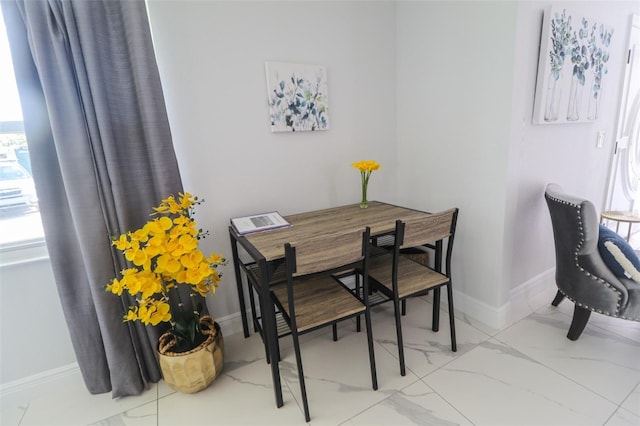 dining room featuring baseboards and marble finish floor