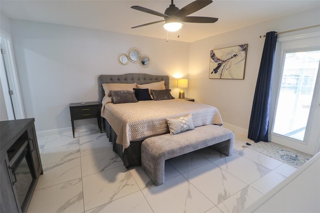 bedroom featuring marble finish floor, a ceiling fan, and baseboards