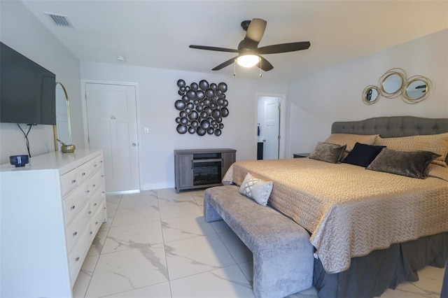 bedroom with visible vents, marble finish floor, a fireplace, baseboards, and ceiling fan