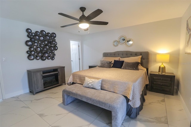 bedroom featuring marble finish floor, a fireplace, baseboards, and ceiling fan