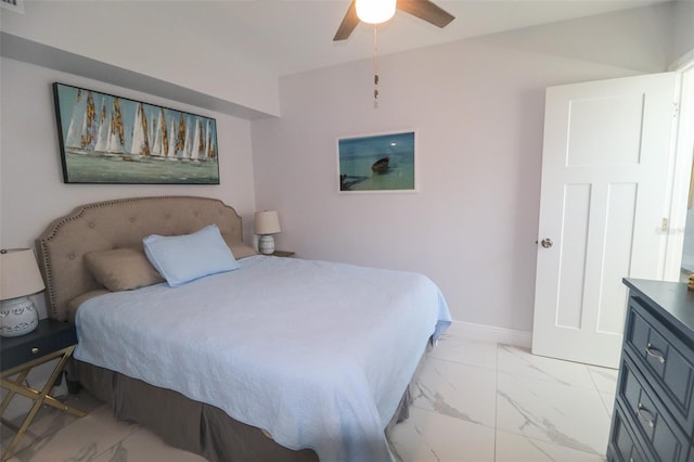 bedroom featuring baseboards, marble finish floor, and a ceiling fan