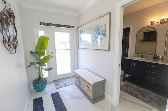 foyer with baseboards, marble finish floor, and crown molding