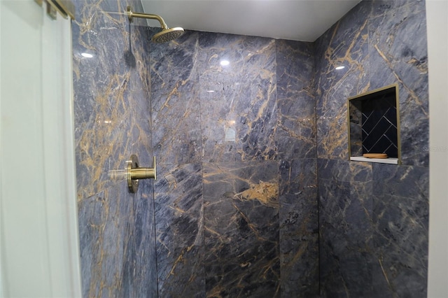 bathroom featuring a marble finish shower