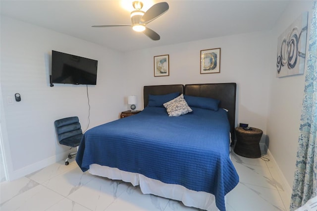 bedroom featuring baseboards, marble finish floor, and a ceiling fan