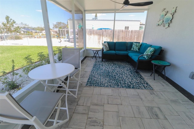 sunroom featuring ceiling fan