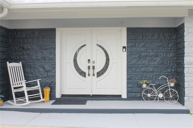 view of exterior entry with covered porch