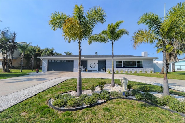 817 Blue Heron Blvd, Ruskin, FL 33570 - single story home with an attached garage, concrete driveway, a chimney, and a front lawn