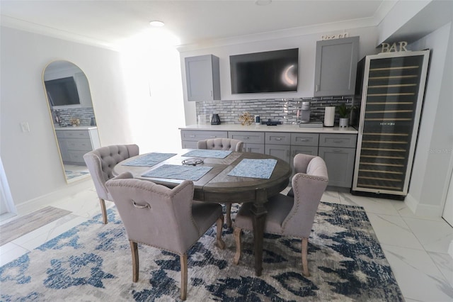 817 Blue Heron Blvd, Ruskin, FL 33570 - dining room with beverage cooler, light marble finish flooring, crown molding, baseboards, and a bar