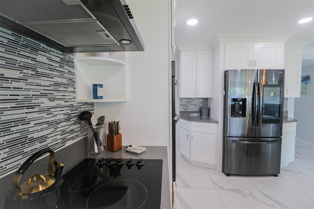 817 Blue Heron Blvd, Ruskin, FL 33570 - kitchen with stainless steel fridge, exhaust hood, backsplash, white cabinetry, and light marble finish flooring