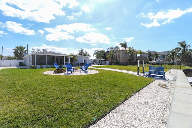 817 Blue Heron Blvd, Ruskin, FL 33570 - view of yard featuring a sunroom, a fire pit, a gate, a residential view, and a patio area