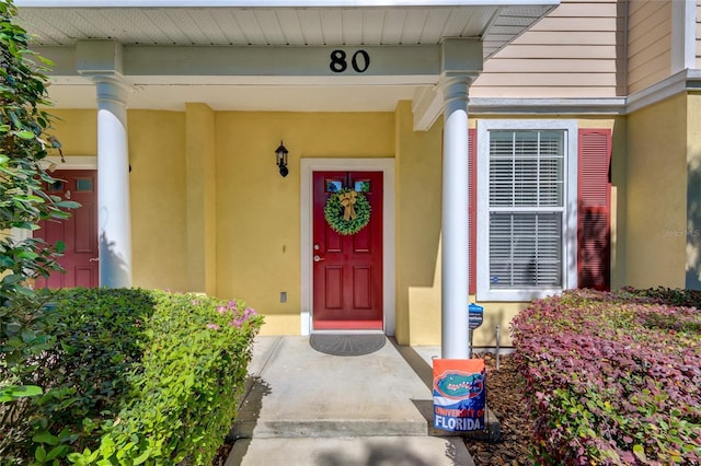 doorway to property featuring stucco siding