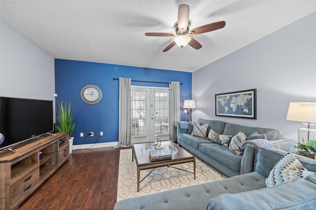 living area with baseboards, a ceiling fan, and wood finished floors