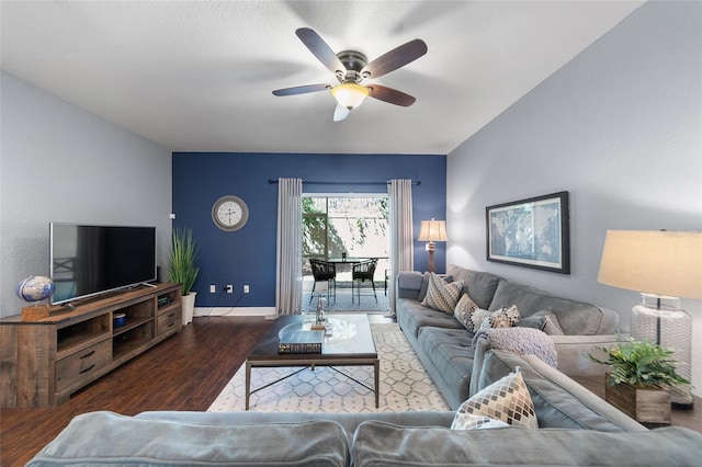 living room with baseboards, wood finished floors, and a ceiling fan