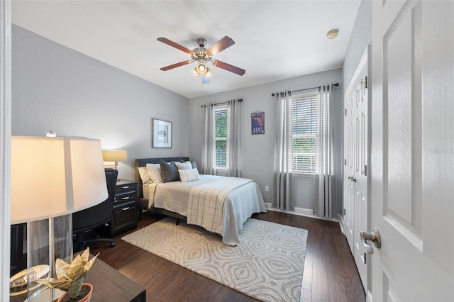 bedroom with dark wood-type flooring and a ceiling fan