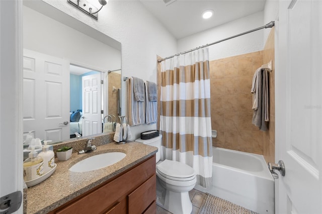 full bathroom featuring tile patterned floors, toilet, vanity, and shower / bathtub combination with curtain