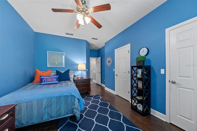 bedroom featuring visible vents, baseboards, and wood finished floors