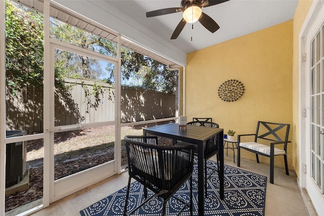 sunroom / solarium with a ceiling fan