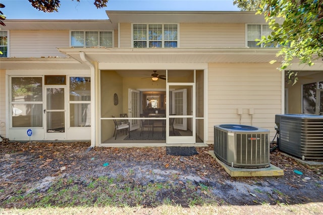 back of property with central air condition unit and a sunroom