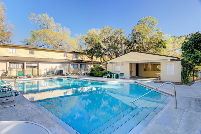 pool featuring a patio and fence