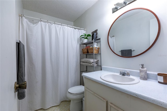 full bath with vanity, toilet, and a textured ceiling