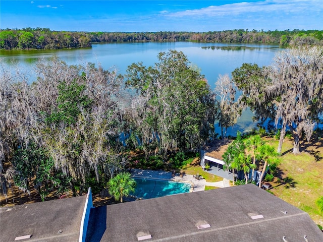 aerial view featuring a wooded view and a water view