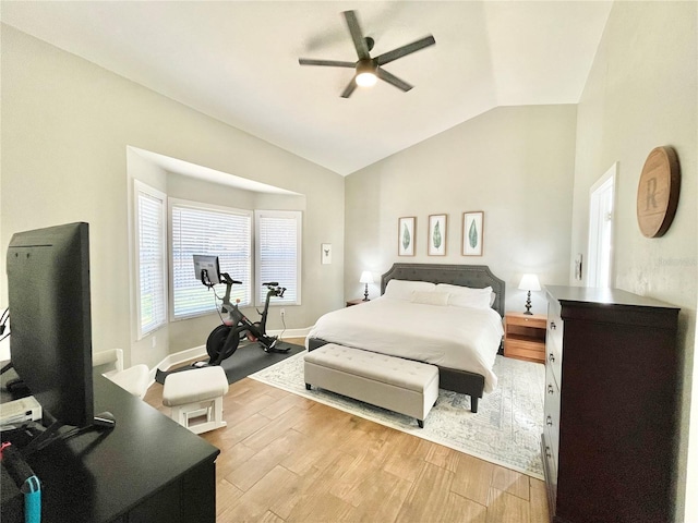 bedroom featuring ceiling fan, baseboards, light wood-type flooring, and lofted ceiling