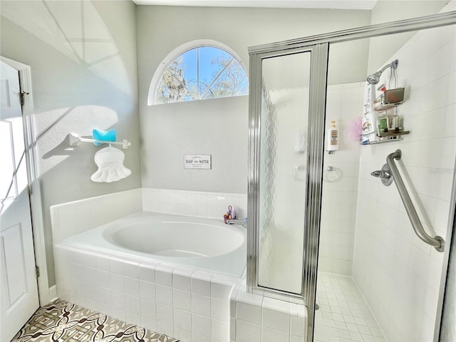 full bathroom featuring a stall shower and a bath