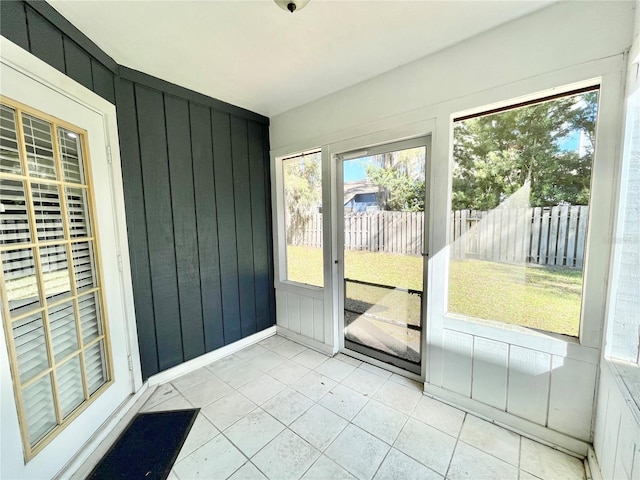 unfurnished sunroom featuring a healthy amount of sunlight