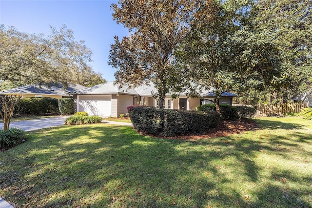 view of front of house featuring a front yard, an attached garage, and concrete driveway