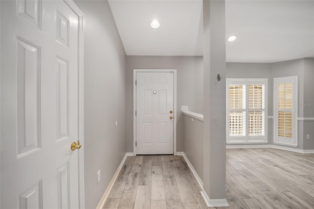 entryway with recessed lighting, light wood-type flooring, and baseboards