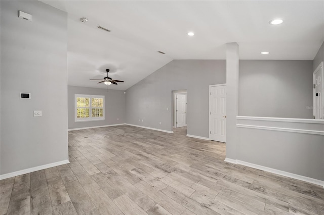 unfurnished living room with a ceiling fan, lofted ceiling, wood finished floors, and baseboards