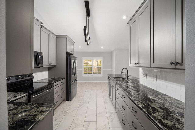 kitchen featuring gray cabinets, range with electric stovetop, freestanding refrigerator, marble finish floor, and a sink