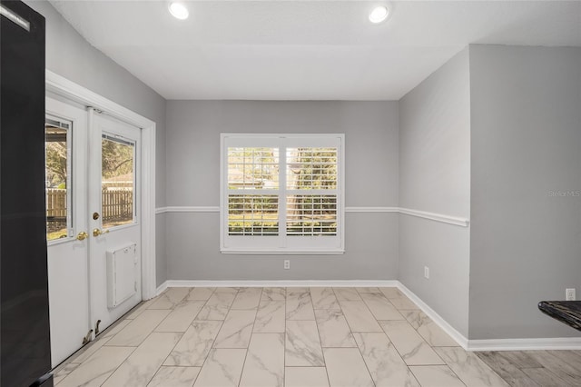 interior space with recessed lighting, marble finish floor, and baseboards