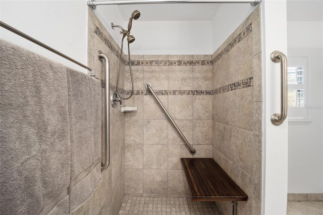 full bath with a tile shower