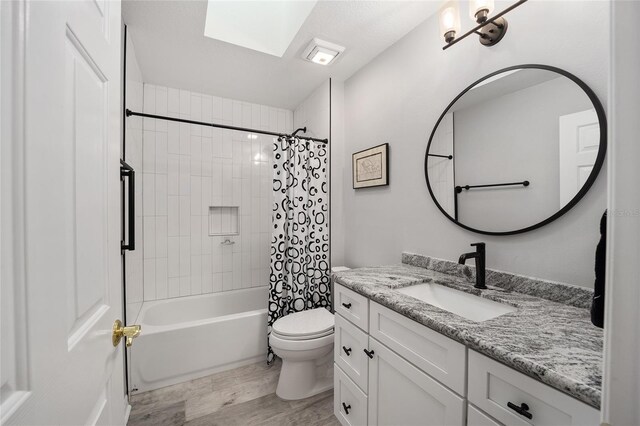 bathroom with toilet, shower / bath combo, wood finished floors, and vanity