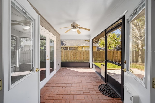 sunroom / solarium featuring ceiling fan