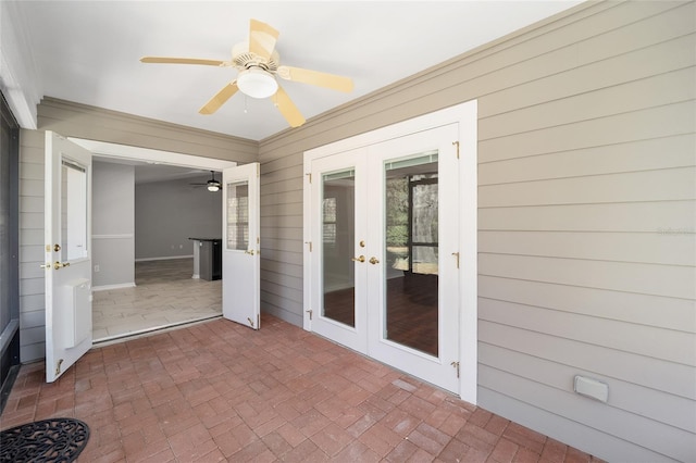 unfurnished sunroom with french doors and a ceiling fan