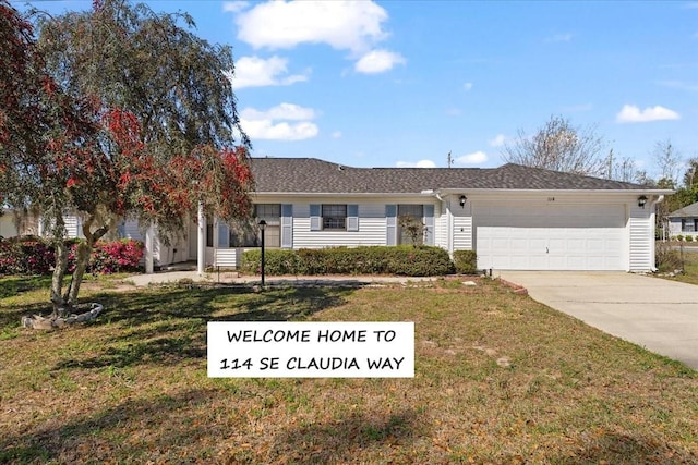 single story home with driveway, a front lawn, and a garage