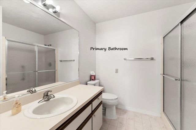 full bath featuring baseboards, toilet, a stall shower, and vanity