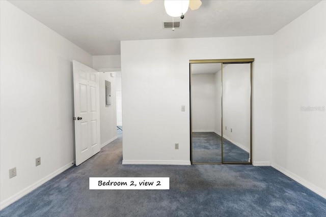 unfurnished bedroom featuring visible vents, a ceiling fan, a closet, carpet, and baseboards