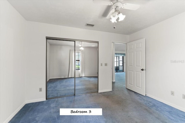 unfurnished bedroom with baseboards, visible vents, carpet floors, and a closet