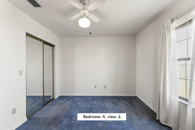 unfurnished bedroom with visible vents, a ceiling fan, a closet, carpet, and baseboards