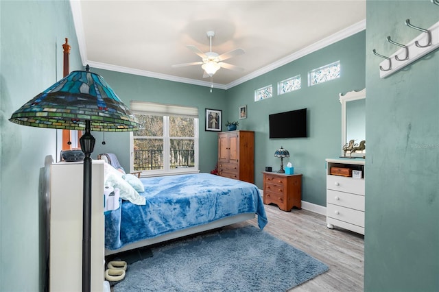 bedroom featuring wood finished floors, baseboards, and ornamental molding