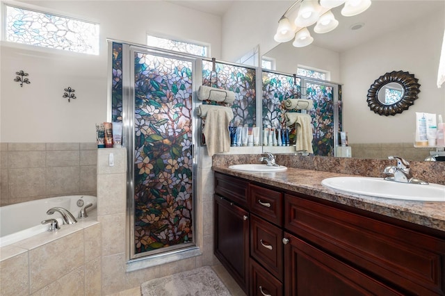 full bath with a sink, a garden tub, and a wealth of natural light