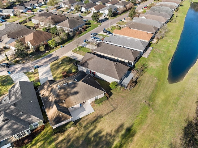 drone / aerial view featuring a residential view and a water view