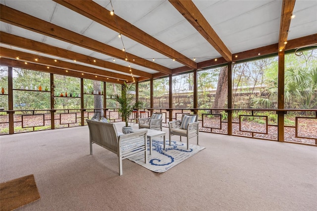 unfurnished sunroom with beam ceiling and a healthy amount of sunlight