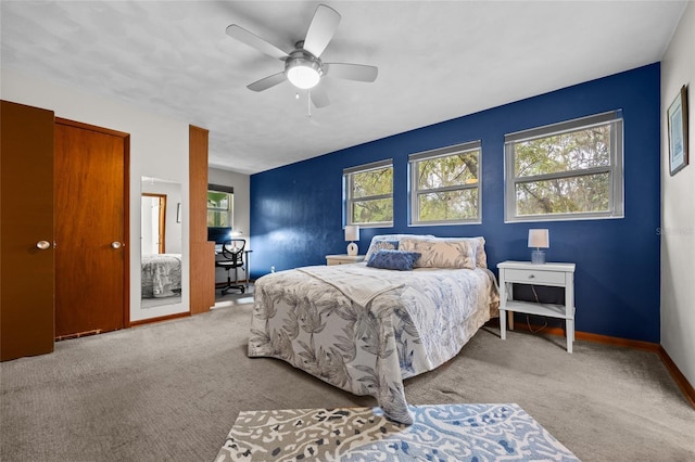 carpeted bedroom with baseboards and a ceiling fan